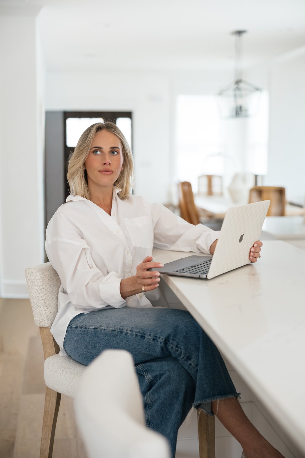 Fortáy founder seated at a bright kitchen island with her laptop